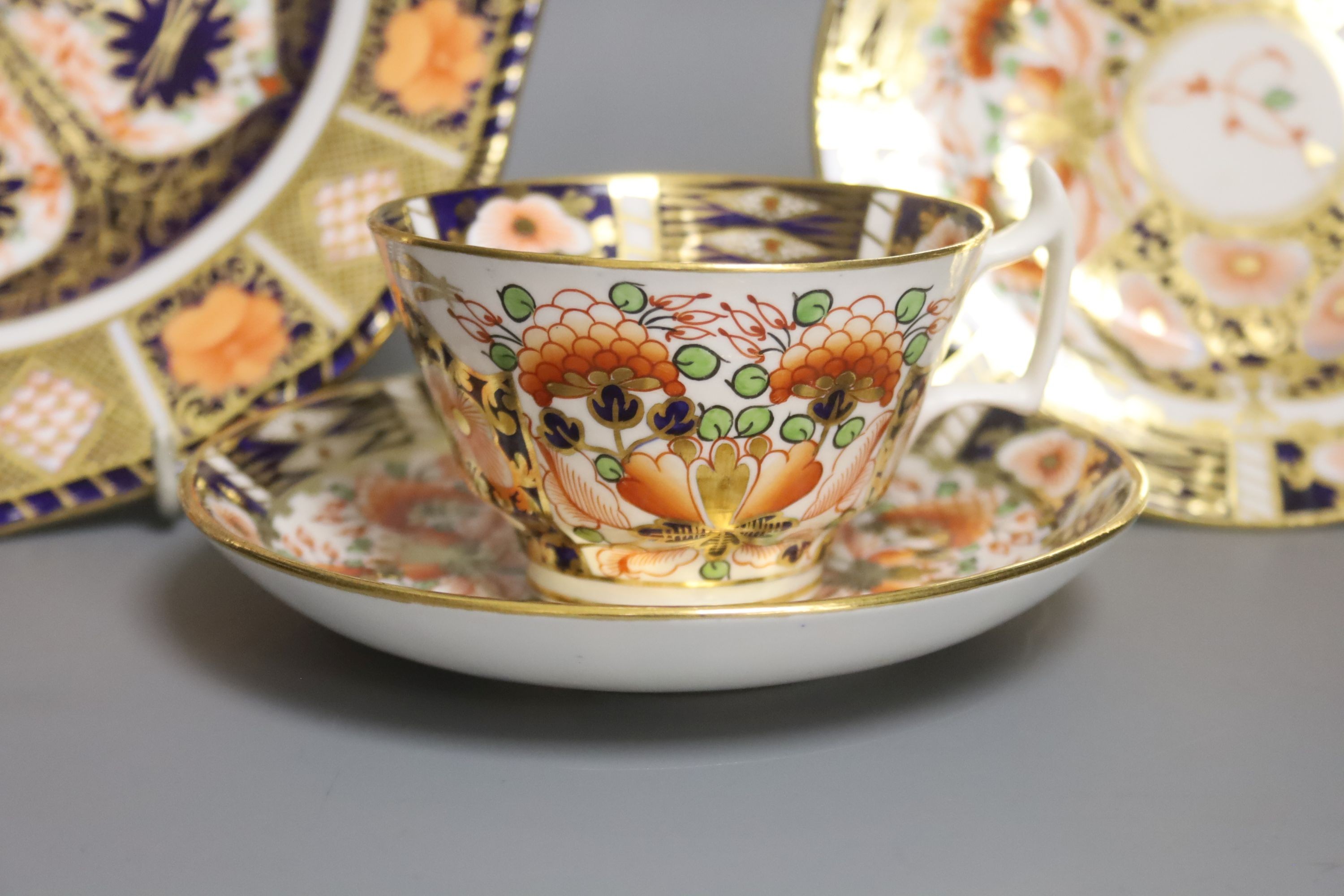 A Derby 1128 Imari pattern plate and Sampson Hancock Derby trio